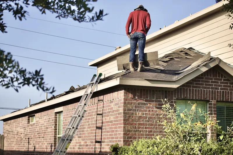 Professional roofer working on a residential roof in Riviera Isles